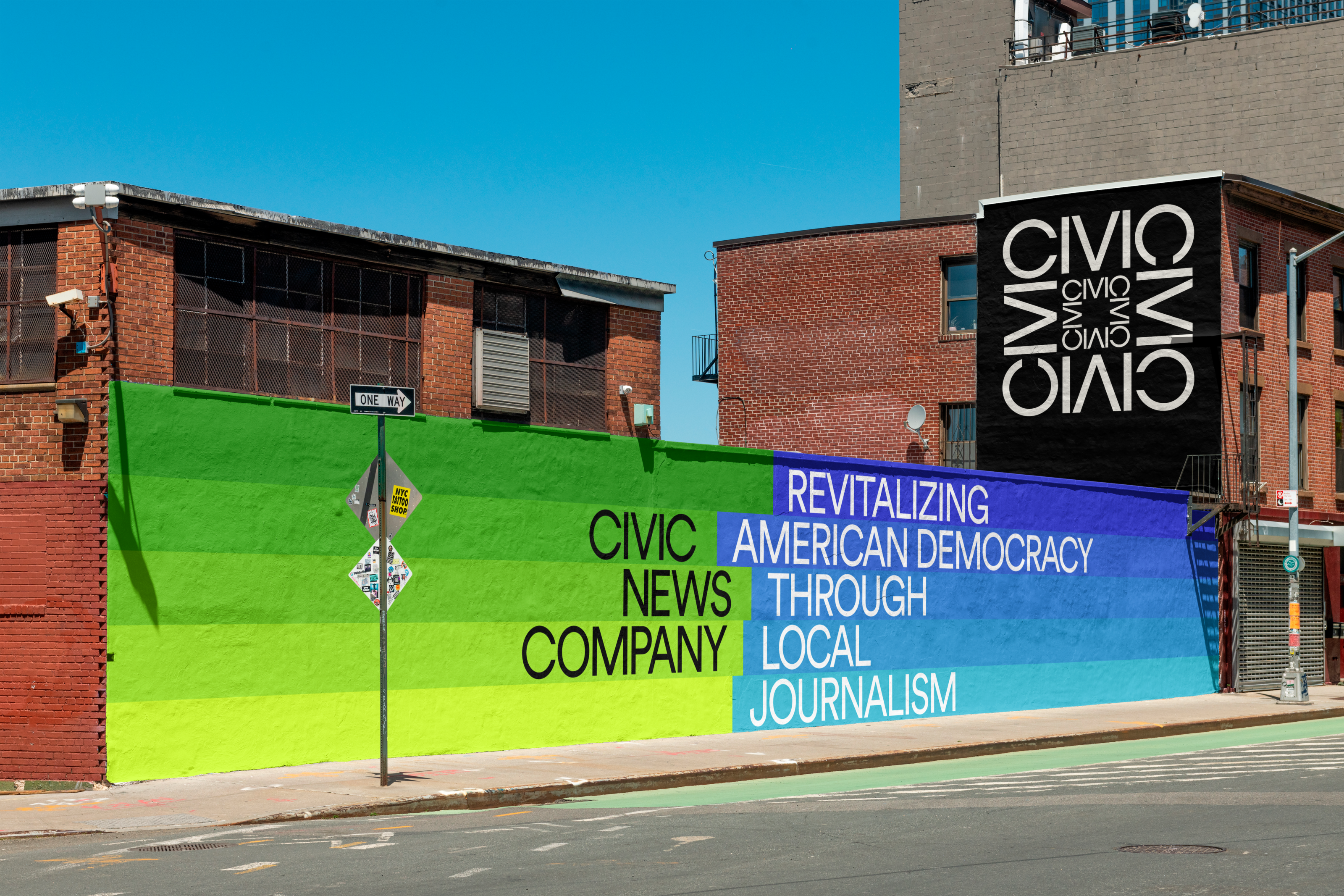 An image of a mural on a brick wall for Civic News Company that showcases the brand colors, logos, and brand messaging