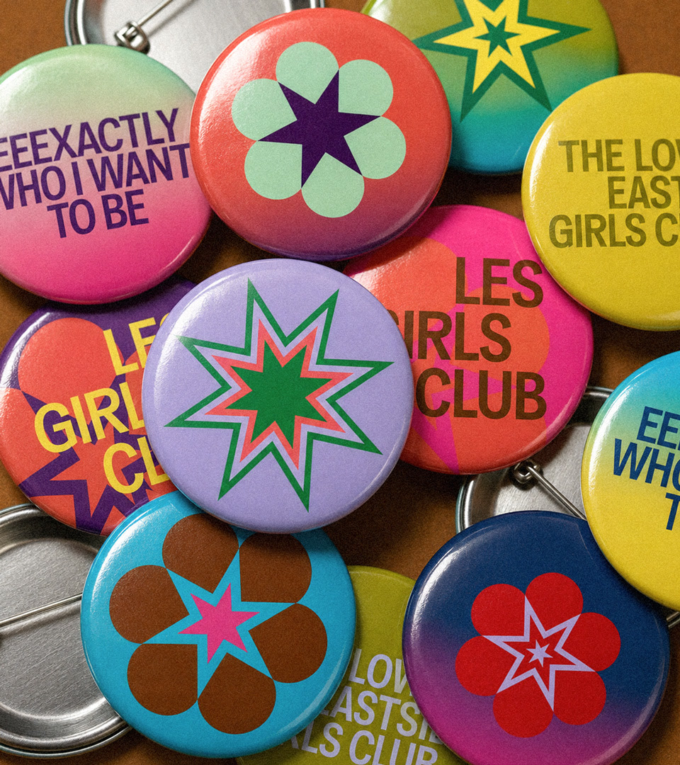 t﻿op down view of a variety of color buttons with the lesgc branding