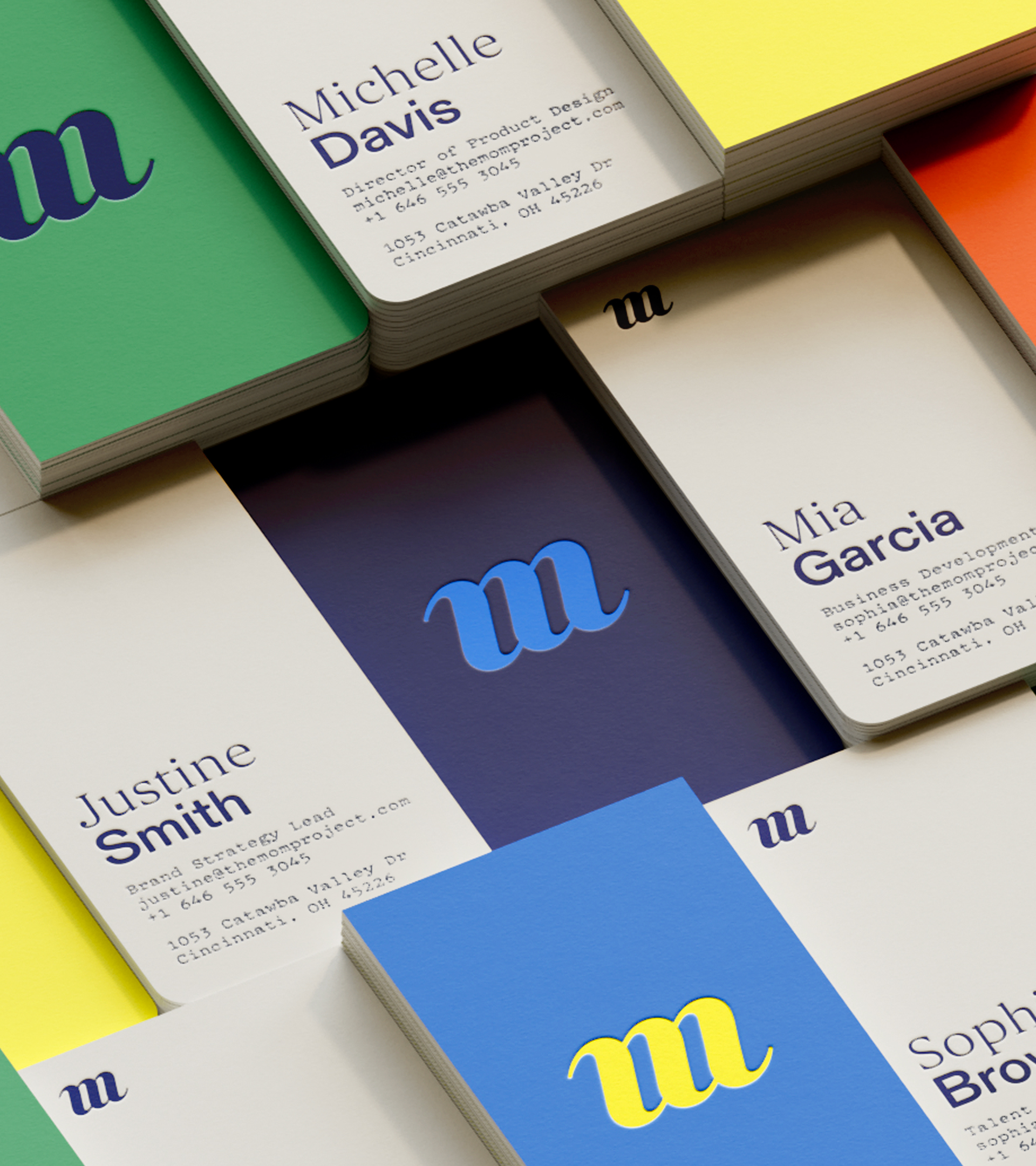 s﻿tacks of business cards showcasing The Mom Project monogram